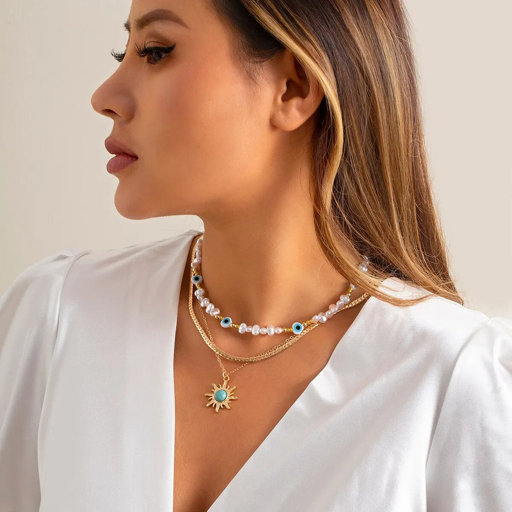 Set di Collane a Strati Parel & Occhio Maligno – Ciondolo Sole Boho