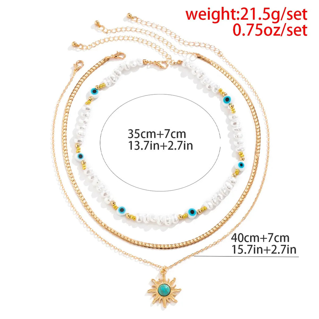 Set di Collane a Strati Parel & Occhio Maligno – Ciondolo Sole Boho